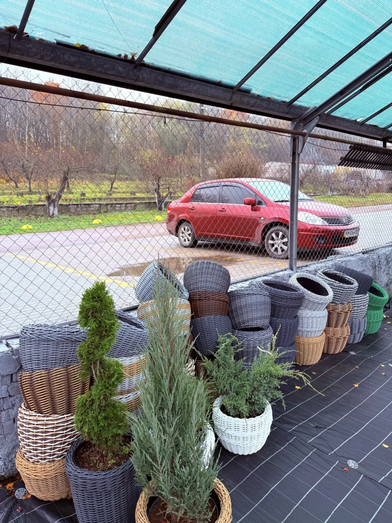 Baskets and a red car outside.